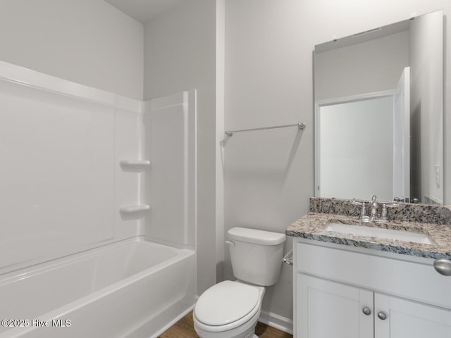 full bathroom featuring toilet, tub / shower combination, hardwood / wood-style floors, and vanity