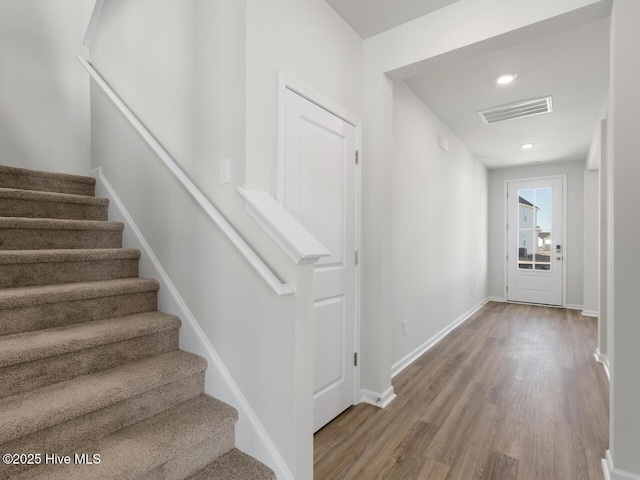 stairway featuring wood-type flooring