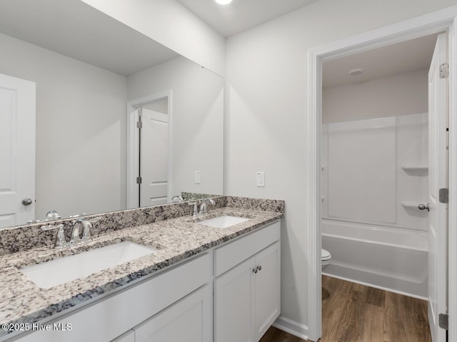 full bathroom with toilet, vanity, shower / tub combination, and hardwood / wood-style flooring