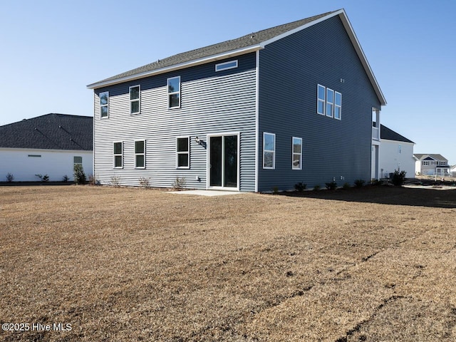 back of house featuring a yard