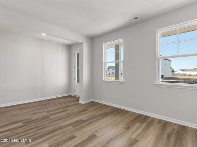 unfurnished room with hardwood / wood-style floors