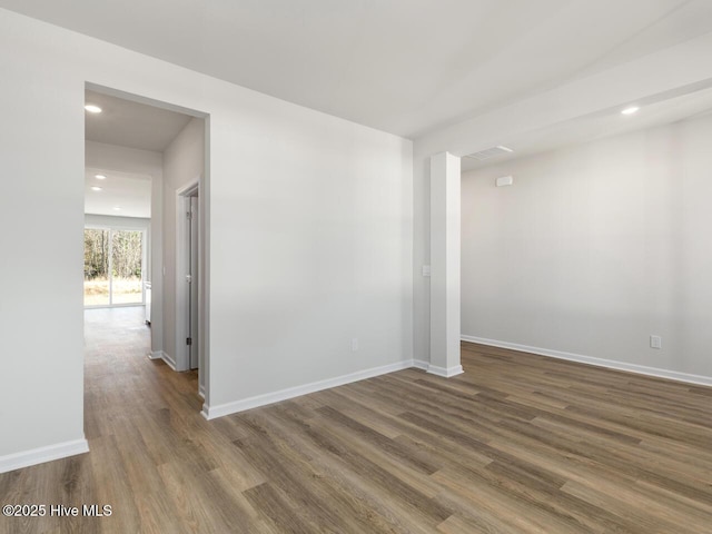 empty room featuring dark hardwood / wood-style flooring