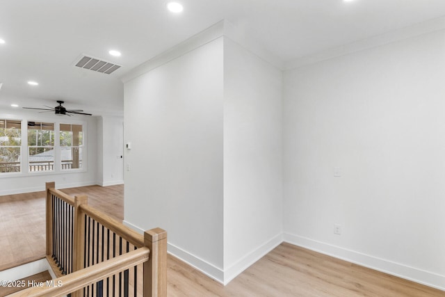 hallway with crown molding and hardwood / wood-style flooring