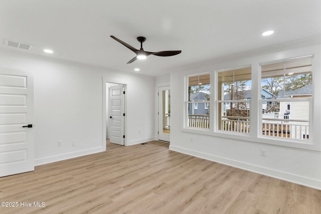 unfurnished room with crown molding, ceiling fan, and light wood-type flooring