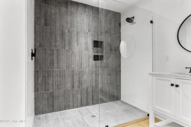 bathroom featuring vanity and a tile shower