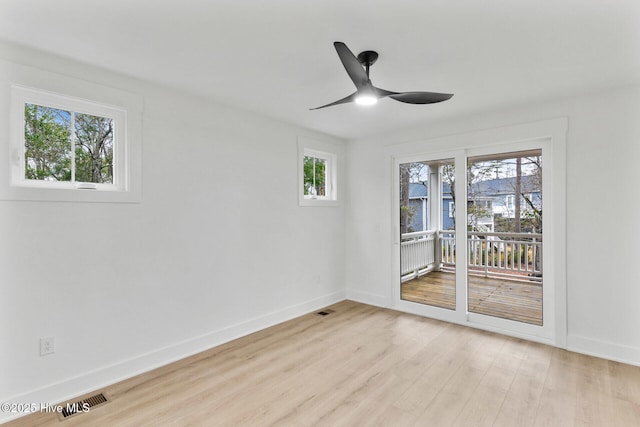 empty room with ceiling fan and light hardwood / wood-style flooring