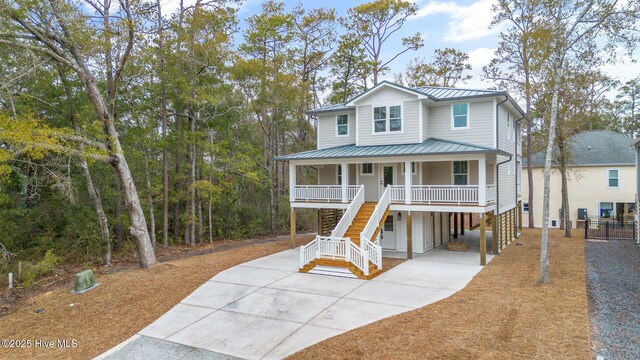 coastal inspired home with a porch and a carport