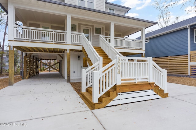 coastal inspired home with a carport and a porch