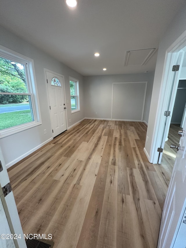 entrance foyer featuring baseboards, light wood-style flooring, and recessed lighting