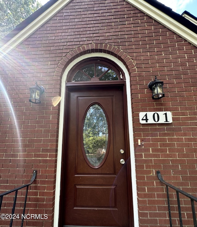 view of exterior entry with brick siding