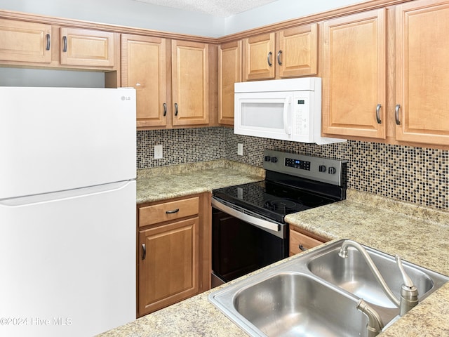 kitchen featuring a textured ceiling, white appliances, backsplash, and sink