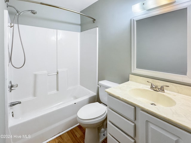 full bathroom featuring hardwood / wood-style floors, vanity, toilet, and shower / bathtub combination