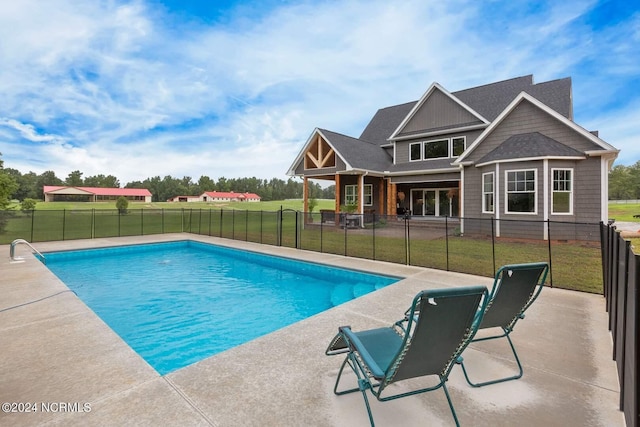 view of swimming pool with a yard and a patio