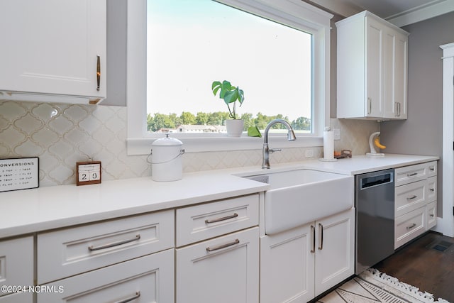 kitchen featuring backsplash, sink, white cabinets, and stainless steel dishwasher