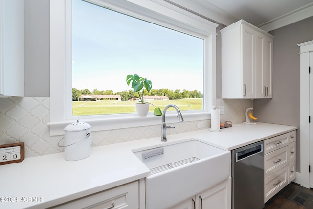 kitchen with dishwasher, decorative backsplash, white cabinets, and sink