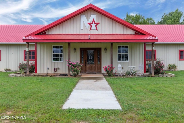 view of front facade with covered porch and a front yard