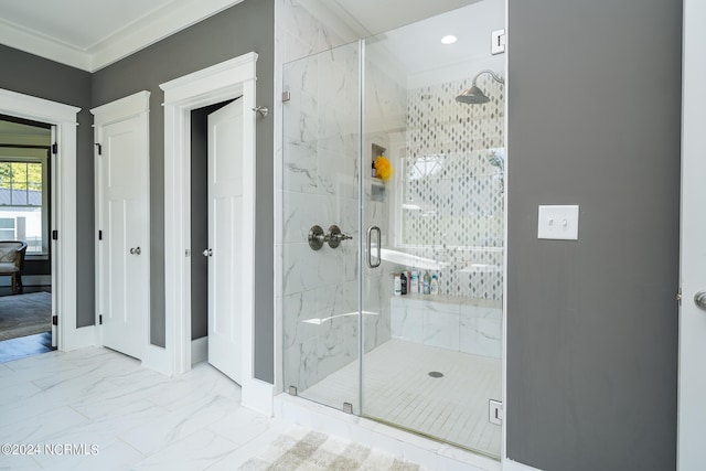 bathroom with crown molding and a shower with shower door