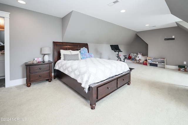 bedroom with light carpet and lofted ceiling