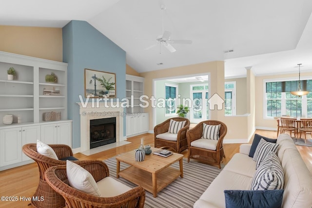 2788 Creek Bridge Ct, Southport, NC 28461 - living area featuring a ceiling fan, light wood-style flooring, a fireplace, and vaulted ceiling