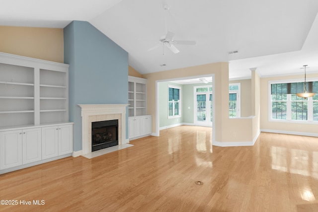2788 Creek Bridge Ct, Southport, NC 28461 - unfurnished living room with a ceiling fan, light wood finished floors, a fireplace, vaulted ceiling, and built in features