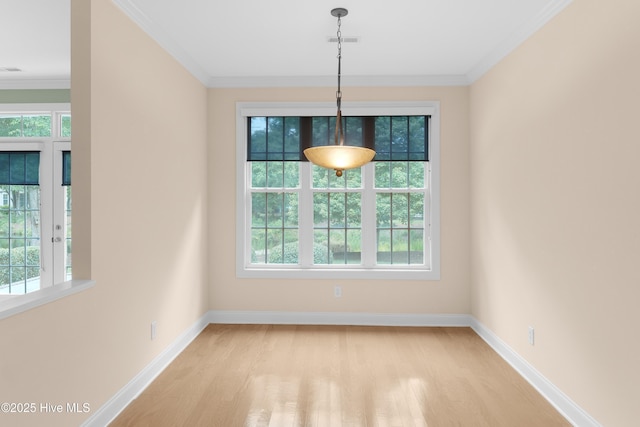 2788 Creek Bridge Ct, Southport, NC 28461 - unfurnished dining area with plenty of natural light, light wood finished floors, baseboards, and crown molding