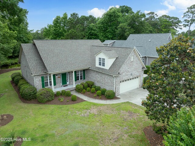 2788 Creek Bridge Ct, Southport, NC 28461 - view of front facade featuring a shingled roof, a garage, and a front yard