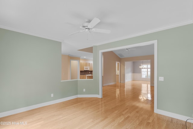 2788 Creek Bridge Ct, Southport, NC 28461 - spare room with ornamental molding, light wood-style flooring, a chandelier, ceiling fan, and baseboards