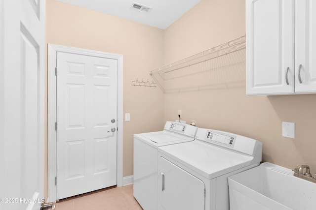 2788 Creek Bridge Ct, Southport, NC 28461 - laundry room featuring cabinet space, washer and dryer, and light tile patterned floors
