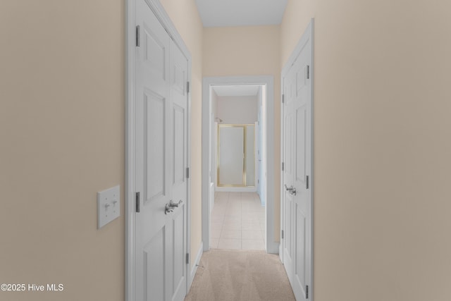 2788 Creek Bridge Ct, Southport, NC 28461 - hallway with tile patterned flooring, carpet, and baseboards