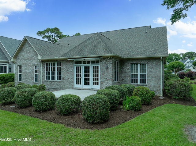 2788 Creek Bridge Ct, Southport, NC 28461 - back of property featuring a shingled roof, a patio area, and brick siding