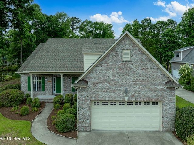 2788 Creek Bridge Ct, Southport, NC 28461 - view of front facade featuring driveway, a porch, brick siding, and an attached garage