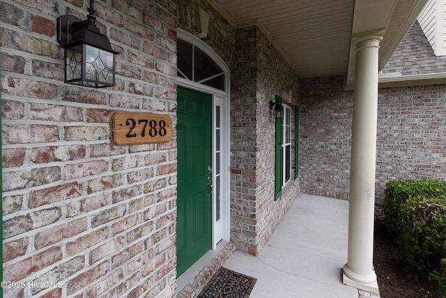 2788 Creek Bridge Ct, Southport, NC 28461 - entrance to property featuring a porch, brick siding, and a shingled roof
