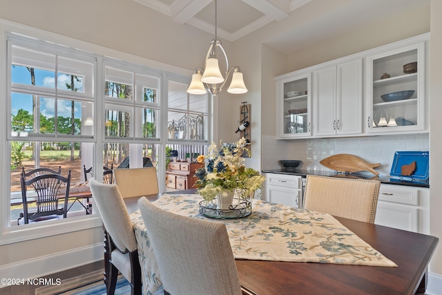 dining area with beamed ceiling, coffered ceiling, and hardwood / wood-style flooring