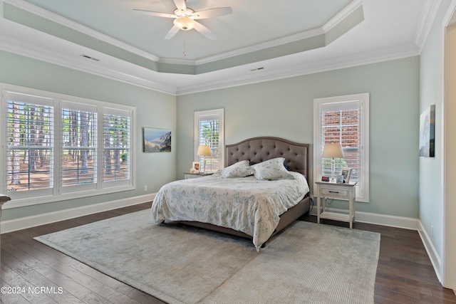 bedroom featuring multiple windows, ceiling fan, dark hardwood / wood-style floors, and ornamental molding