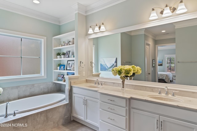 bathroom with vanity, crown molding, and tiled tub