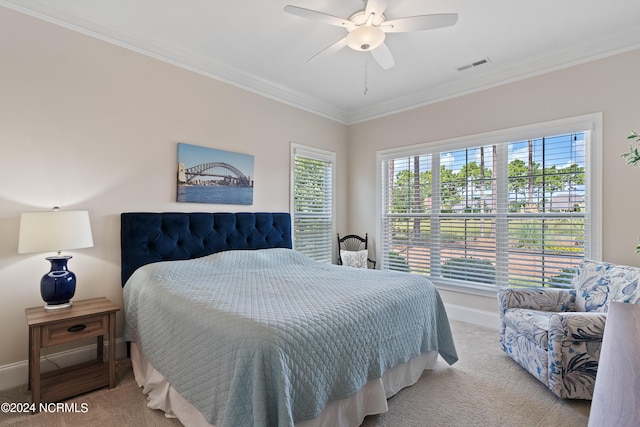 bedroom with light colored carpet, ceiling fan, and crown molding