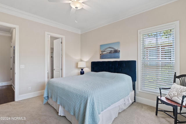 carpeted bedroom with ceiling fan and crown molding