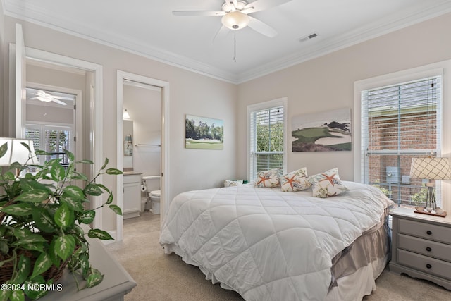 carpeted bedroom featuring ceiling fan, ornamental molding, and connected bathroom