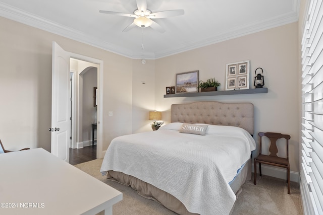 bedroom featuring carpet, ceiling fan, and crown molding