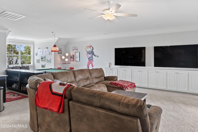 living room with crown molding, ceiling fan, and light carpet