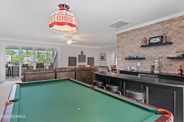 rec room with ornamental molding, ceiling fan, carpet floors, bar, and pool table