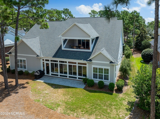 back of house with a yard and a patio