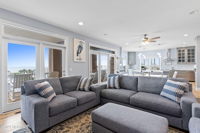 living room with ceiling fan and wood-type flooring