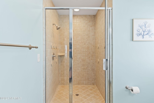 bathroom with a shower with door