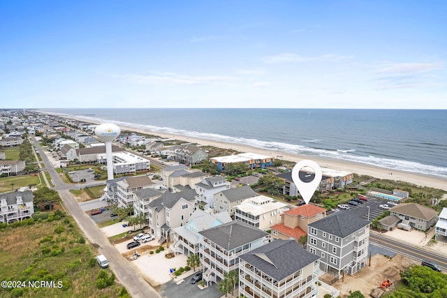 drone / aerial view featuring a beach view and a water view