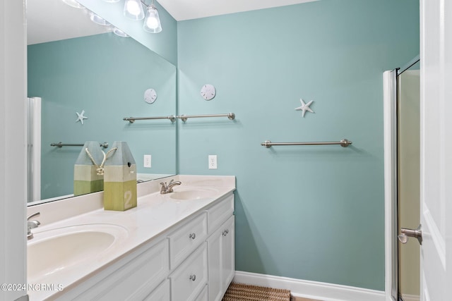 bathroom featuring tile patterned flooring, an enclosed shower, and vanity