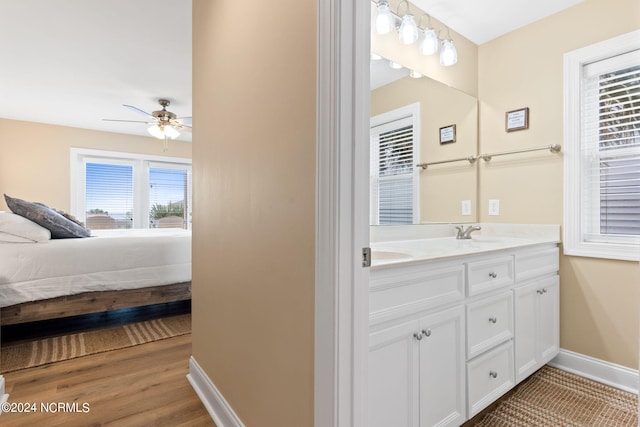 bathroom featuring ceiling fan, vanity, and hardwood / wood-style floors