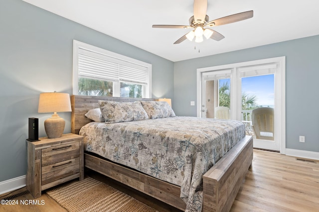 bedroom featuring light hardwood / wood-style flooring, ceiling fan, multiple windows, and access to outside