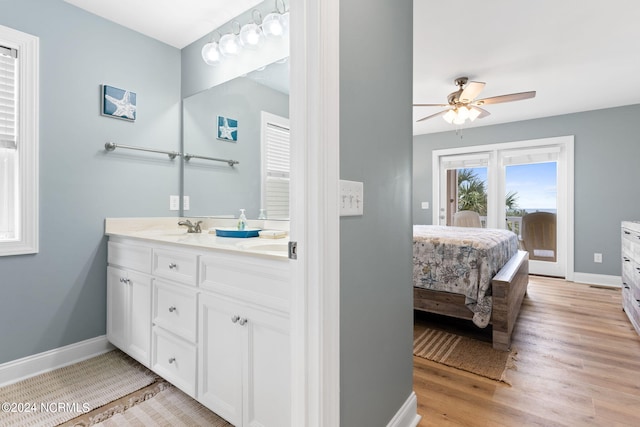 bathroom featuring ceiling fan, hardwood / wood-style flooring, and vanity