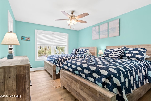 bedroom with light wood-type flooring and ceiling fan